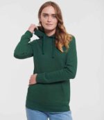 Model wearing the Russell Athletic Ladies Authentic Hooded Sweatshirt in Bottle Green
