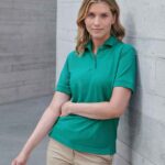 Henbury H401 ladies piqué polo shirt in Jade, worn by a model