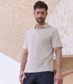 Henbury H475 Coolplus wicking piqué polo shirt in Natural, worn by a model